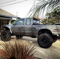 a silver truck parked in front of a house