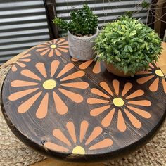 a wooden table topped with a potted plant on top of it