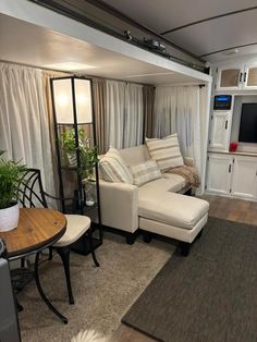 a living room filled with furniture and a flat screen tv