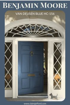 a blue front door with an arched glass window above it and a cat standing in the doorway