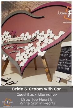 the wedding sign is made out of paper and has hearts cut out of it to look like a heart