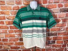 "90s Izod striped polo. Lightly used no major issues MEASURES -  23\" pit to pit and 26.5\" long in front, 29\" long in back TAGGED - ~ BE SURE TO CHECK OUT MY ENTIRE SHOP ~ - This is a TRUE VINTAGE item! Vintage clothing sizing varies wildly ALWAYS use the measurements and info provided in the listing to assure proper fit! Unless the words \"deadstock\" or \"unworn\" are used please understand this is a USED item. RETURNS - My policy is NO RETURNS but I will make an exception if you agree to cover the return shipping as well as forfeit the shipping I paid to ship the item. If I made an error I will make it right 100% but I am not responsible if you change your mind/\"item does not fit\". Please use the measurements provided if you don't know how ask me I will gladly help you :) ** Why buy Green Polo Shirt With Striped Collar And Short Sleeves, Green Short Sleeve Polo Shirt With Striped Collar, Green Short Sleeve Polo Shirt For Streetwear, Green Cotton Polo Shirt For Streetwear, Green Collared T-shirt For Streetwear, Retro Green Short Sleeve Polo Shirt, Casual Green Polo Shirt For Streetwear, Vintage Green Short Sleeve Polo Shirt, Vintage Green Cotton Polo Shirt