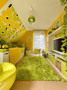 a bedroom with yellow walls and green rugs on the floor next to a television