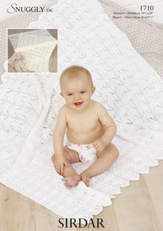 a baby is sitting on a white blanket