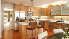 a modern kitchen with wooden cabinets and stainless steel appliances is pictured in this image from the dining room