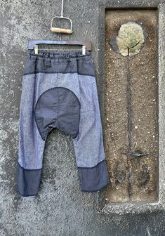 Dark Wash Cotton Trousers, Bohemian Denim Blue Pants With Pockets, Spring Deconstructed Denim Blue Bottoms, Baggy Recycled Denim Pants For Spring, Bohemian Denim Blue Cotton Bottoms, Spring Baggy Recycled Denim Pants, Baggy Patchwork Tapered Leg Pants, Baggy Patchwork Pants With Tapered Leg, Bohemian Style Denim Blue Cotton Pants