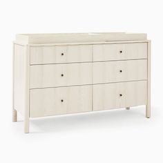 a white dresser with four drawers and two doors on each side, in front of a white background