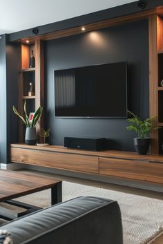 a living room with black walls and wooden entertainment center on the wall is a large flat screen tv