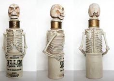 three bottles with skeletons in them sitting next to each other