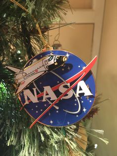 a nasa ornament hanging from a christmas tree