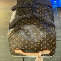 Louis Vuitton | Bags | Louis Vuitton Duffle Roller | Poshmark Designer Duffle Bag For Shopping, Designer Brown Bag For Trips, Luxury Leather Luggage, Designer Luggage For Trips, Luxury Shopping Travel Bag With Luggage Sleeve, Luxury Travel Bag In Signature Coated Canvas, Luxury Signature Coated Canvas Travel Bag, Luxury Brown Coated Canvas Luggage, Luxury Rectangular Luggage