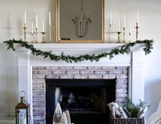 a fireplace decorated for christmas with candles and garland on it's mantel, surrounded by other holiday decorations