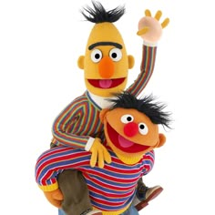 the muppet and his friend are riding on top of each other in front of a white background