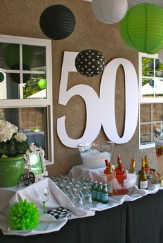 a table topped with lots of drinks and decorations