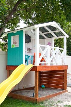 a play house with a slide in the yard