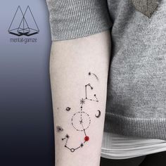 a woman's arm with a tattoo on it that has an image of the zodiac sign