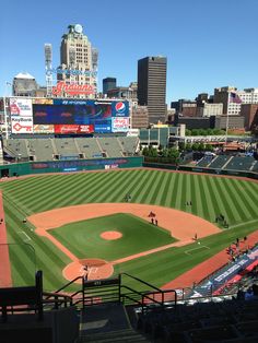 a baseball field with the city skyline in the background