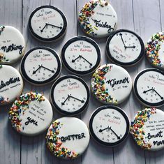 twelve decorated cookies with different time zones and words on them, arranged in the shape of clocks