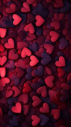 many red and black hearts are arranged in the shape of an abstract pattern on a dark background