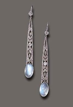 A PAIR OF MOONSTONE & DIAMOND EAR PENDANTS Each old European-cut diamond collet, suspending a rose & old European-cut diamond elongated openwork plaque, to the cabochon moonstone terminal, mounted in platinum. Bijoux Art Nouveau, Edwardian Jewelry, Moonstone Jewelry, Dream Jewelry, Antique Jewellery, A Rose