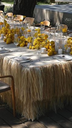 the table is covered with yellow flowers and candles