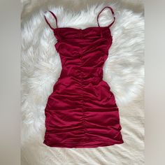 This Dress Was Never Worn But I Don't Have The Tags, Size Xs And Perfect For Homecoming Or Other Occasions Burgundy Ruched Dress For Night Out, Red Ruched Bodycon Dress In Flirty Style, Red Ruched Stretch Mini Dress, Red Ruched Bodycon Dress With Flirty Style, Flirty Red Ruched Bodycon Dress, Burgundy Ruched Mini Dress, Stretch Burgundy Mini Dress, Stretch Mini Length Burgundy Dress, Red Ruched Mini Length Bodycon Dress