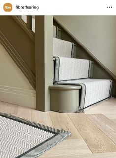 an image of a stair case in the middle of a room with carpet on the floor