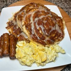 a breakfast plate with eggs, sausages and hashbrowns covered in icing