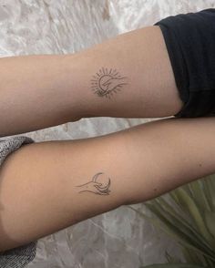 two tattoos on both arms with the sun and moon above them, one is black