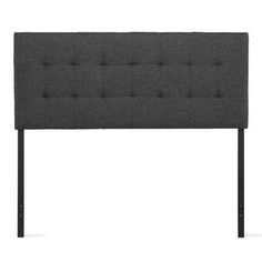 an upholstered headboard with black metal legs and tufted fabric, on a white background