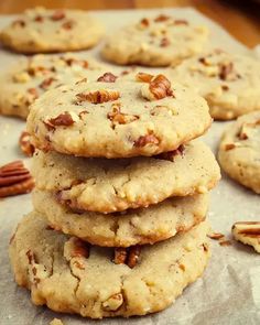 pecan chip cookies stacked on top of each other with pecans scattered around them