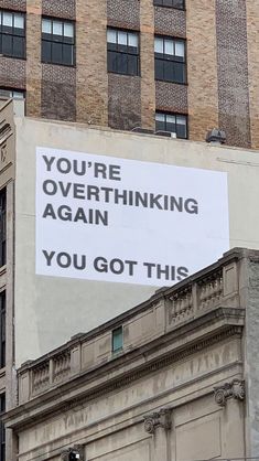 an advertisement on the side of a building that says you're overthiking again you got this