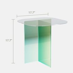 a white table with green and blue lines on the top, next to a height chart