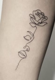 a woman's leg with a rose tattoo on the left side of her thigh