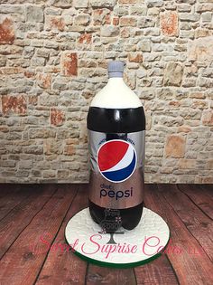 a bottle of pepsi sitting on top of a wooden table