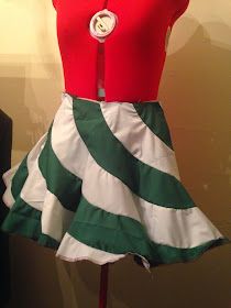 a dress made to look like a skirt with buttons on the top and bottom, sitting on a mannequin