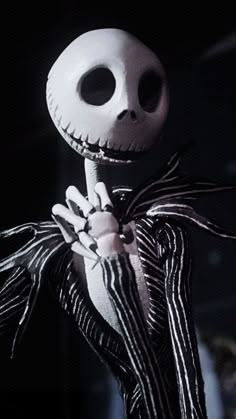 jack skellingy from the nightmare before it is dark and scary, holding his hand up in front of him