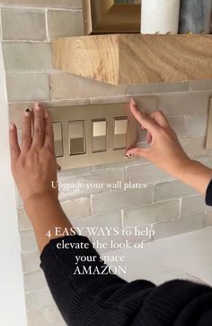 a woman placing tiles on a brick wall with instructions for how to put them together