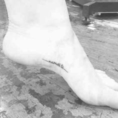 a black and white photo of a person's foot with the word love on it