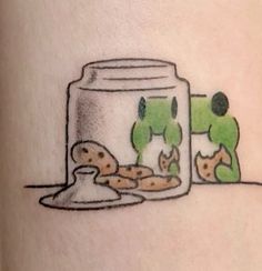 a drawing of a jar with cookies in it on the side of a woman's leg