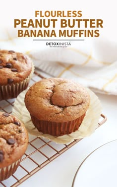 three banana muffins sitting on top of a cooling rack