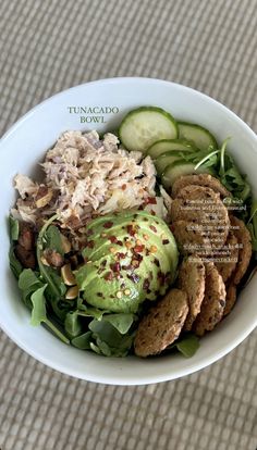 a white bowl filled with salad and cucumbers