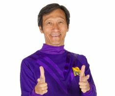 a man in a purple shirt is giving the thumbs up sign with his right hand