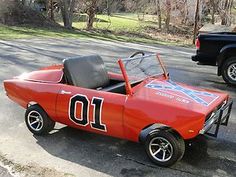 an orange race car with the number 10 painted on it's side is parked in a parking lot