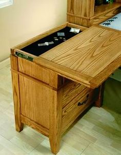 a wooden desk with drawers and a bed in the corner behind it on tile flooring