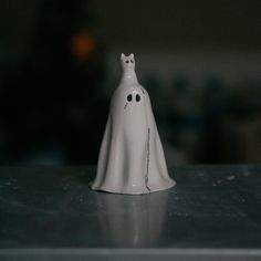 a white ghost figurine sitting on top of a table