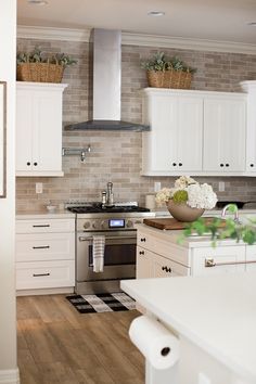 a kitchen with white cabinets and black and white checkered flooring