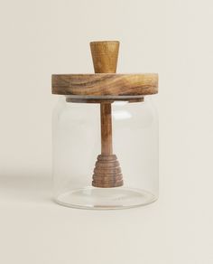 a glass jar with a wooden stick inside