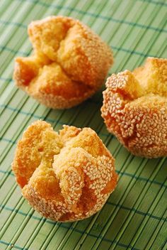 three small pastries sitting on top of a green place mat next to each other