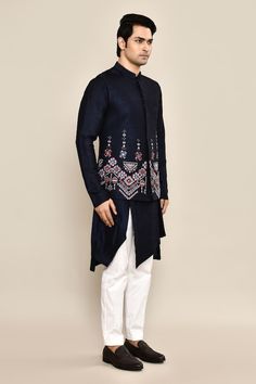 Navy bundi with thread, mirror embroidery in geometric pattern on border. Paired with asymmetric kurta and ivory pant pyjama. - Aza Fashions Fitted Traditional Wear With Geometric Embroidery For Transitional Season, Fitted Traditional Wear With Geometric Embroidery, Traditional Fitted Kurta With Geometric Embroidery, Designer Traditional Kurta With Geometric Embroidery, Designer Kurta With Geometric Embroidery For Festive Occasions, Traditional Bandhgala With Geometric Embroidery For Eid, Traditional Sets With Geometric Embroidery For Transitional Season, Festive Bandhgala With Geometric Embroidery For Eid, Traditional Wear With Geometric Embroidery For Eid